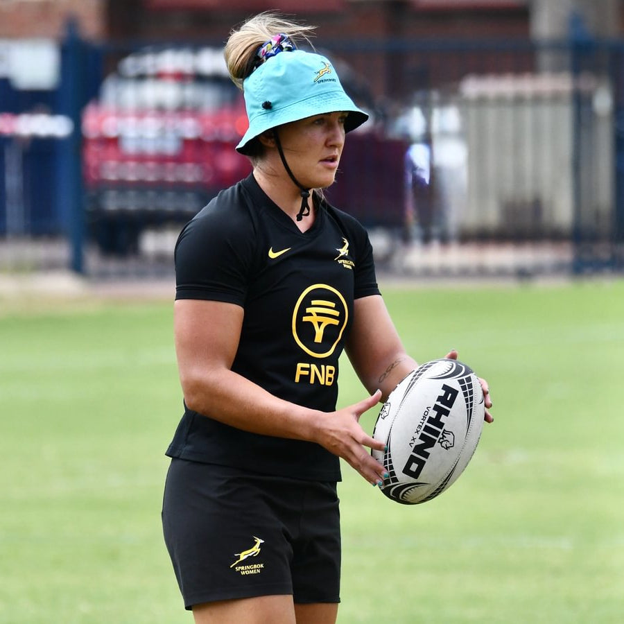 Libbie Janse van Rensburg holding a rugby ball at Bok Women's training on a pitch
