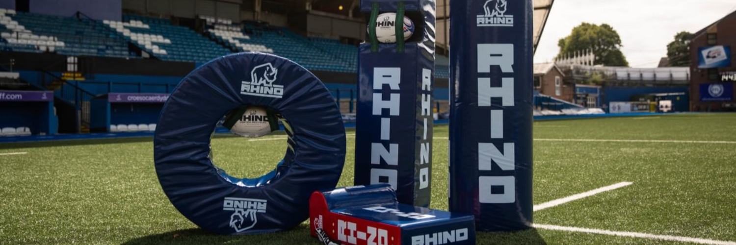 Rhino sports equipment on a sports field with stadium in the background