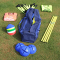 Rugby training equipment including blue balls, a blue bag, and colorful vests on grass